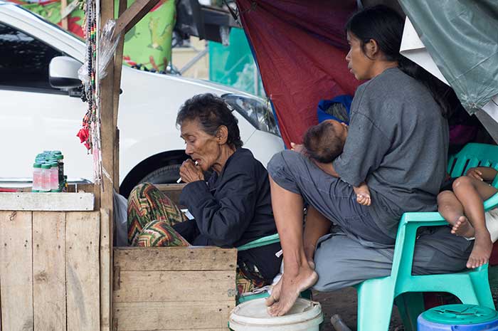 A family selling candles in the Philippines