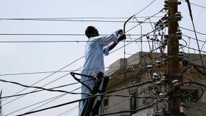 Man fixing power lines in Pakistan 