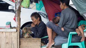 A family selling candles in the Philippines