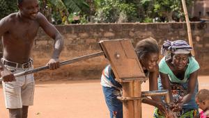 A family collecting water from a well Credit: iStock