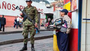 A solider and a street trader in Bogata, Columbia