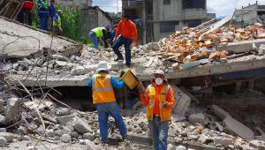 Rescue workers at the scene of a collapsed house following the earthquake in Ecuador