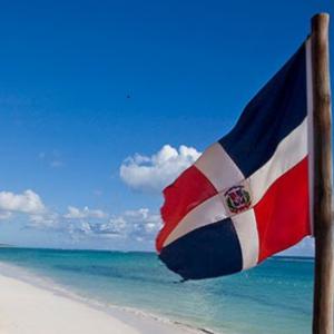 Dominican Republic flag on the beach 
