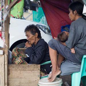 A family selling candles in the Philippines