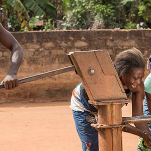 A family collecting water from a well Credit: iStock