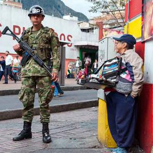 A solider and a street trader in Bogata, Columbia